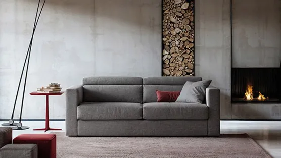 Grey sofa bed with headrest.
